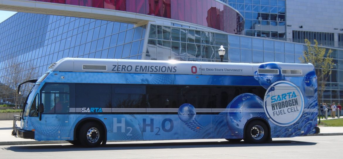 Stark Area Regional Transit Authority. A bus parked outside of a large building.