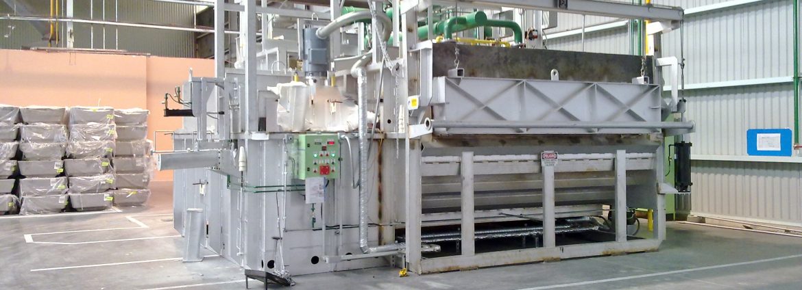Schaefer Group warehouse with a large piece of equipment in view with some stacks of materials in the back left.