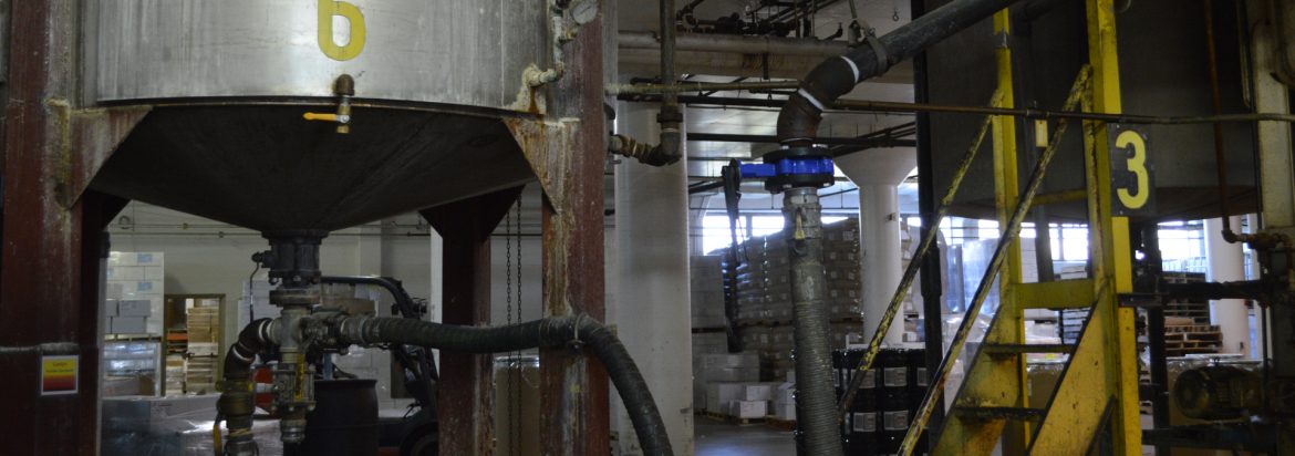 The Evans Adhesive Group. View of a mixing tank with other equipment around.
