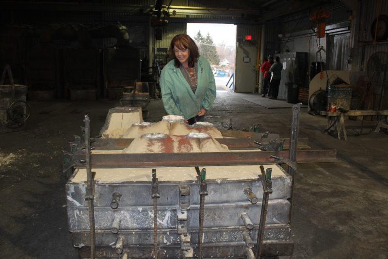 Non-Ferrous Founders' Society Board Member and President of Calumet Brass Foundry (Dolton, Illinois) inspects a mold poured by her production team.