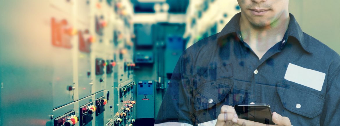 The Association for Packaging and Processing Technologies Technician man using smart phone for control electric in switch gear electrical room of oil and gas platform or plant industrial for monitor process, business and industry concept.